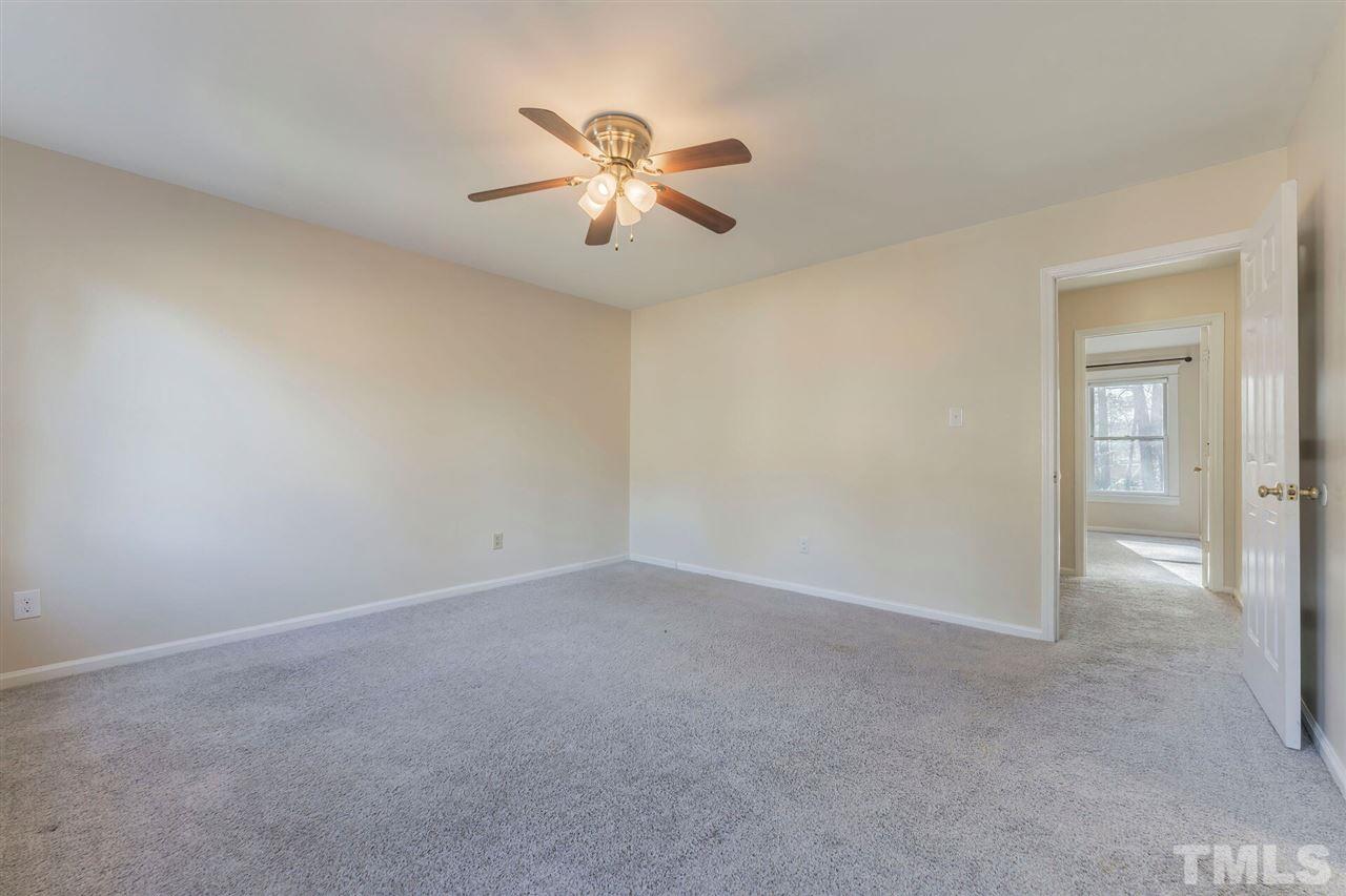 5629 Hamstead Crossing Raleigh, NC 27612 - Photo 15 of 27 an empty room with windows and chandelier fan