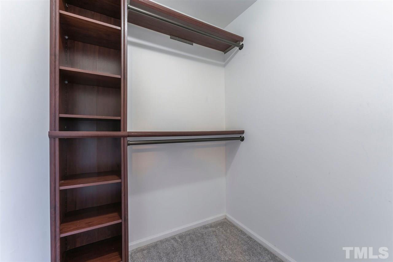 5629 Hamstead Crossing Raleigh, NC 27612 - Photo 16 of 27 a view of walk in closet with empty racks