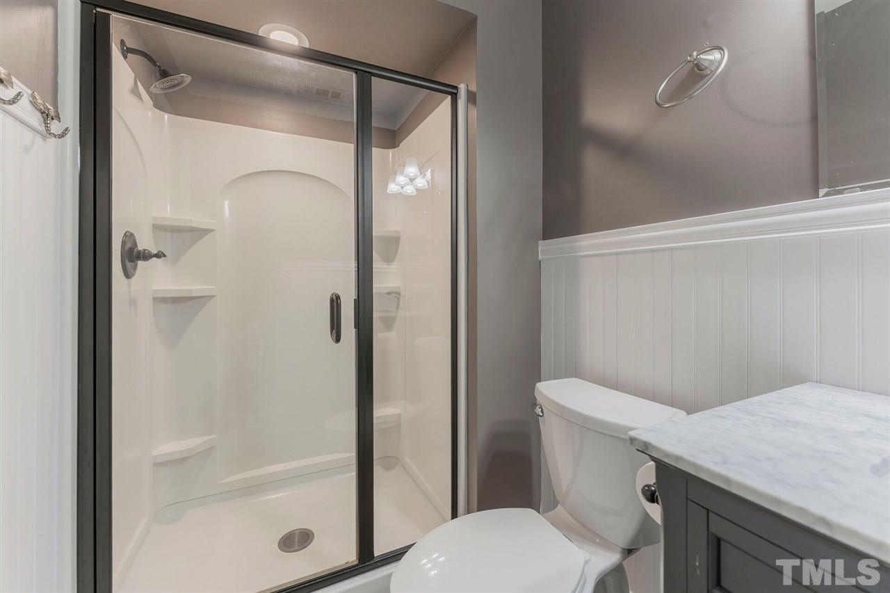 5629 Hamstead Crossing Raleigh, NC 27612 - Photo 18 of 27 a bathroom with a shower a toilet and a sink