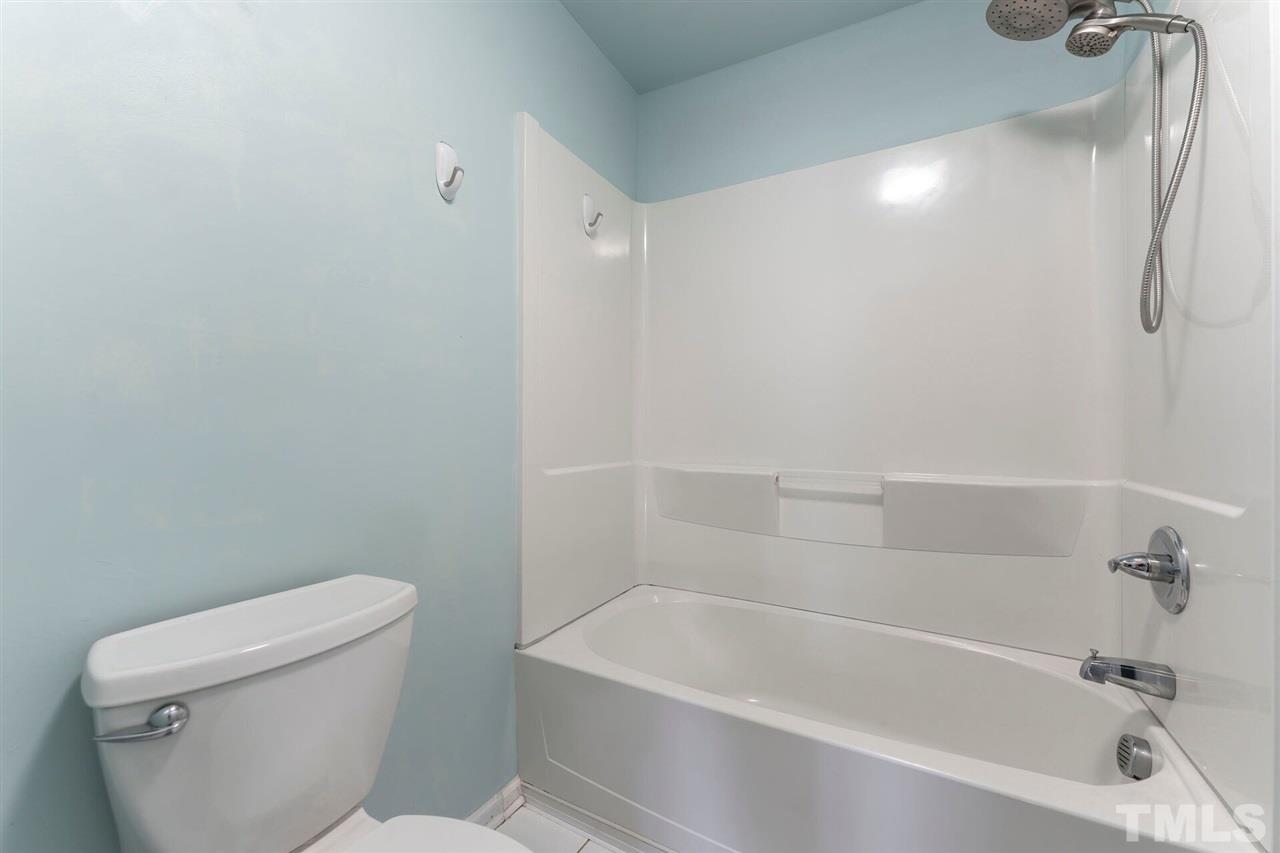 5629 Hamstead Crossing Raleigh, NC 27612 - Photo 23 of 27 a white bath tub sitting next to a white toilet and a shower