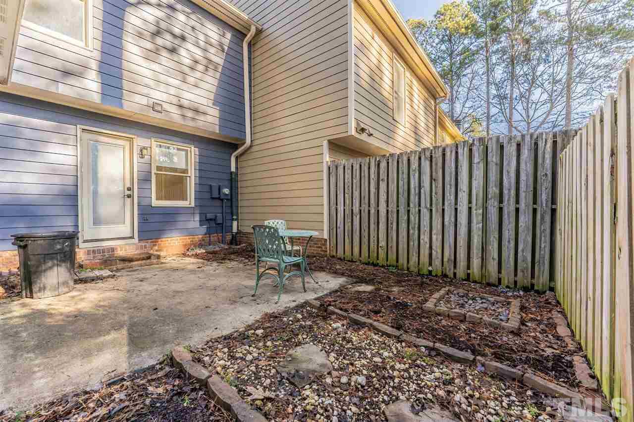 5629 Hamstead Crossing Raleigh, NC 27612 - Photo 26 of 27 a backyard of a house with chairs and wooden fence