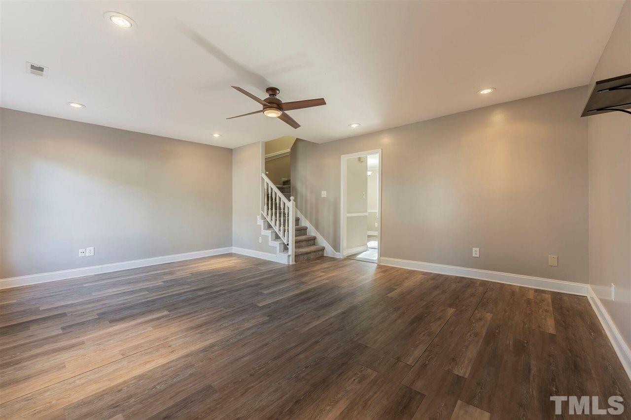 5629 Hamstead Crossing Raleigh, NC 27612 - Photo 4 of 27 a view of an empty room with wooden floor ceiling fan