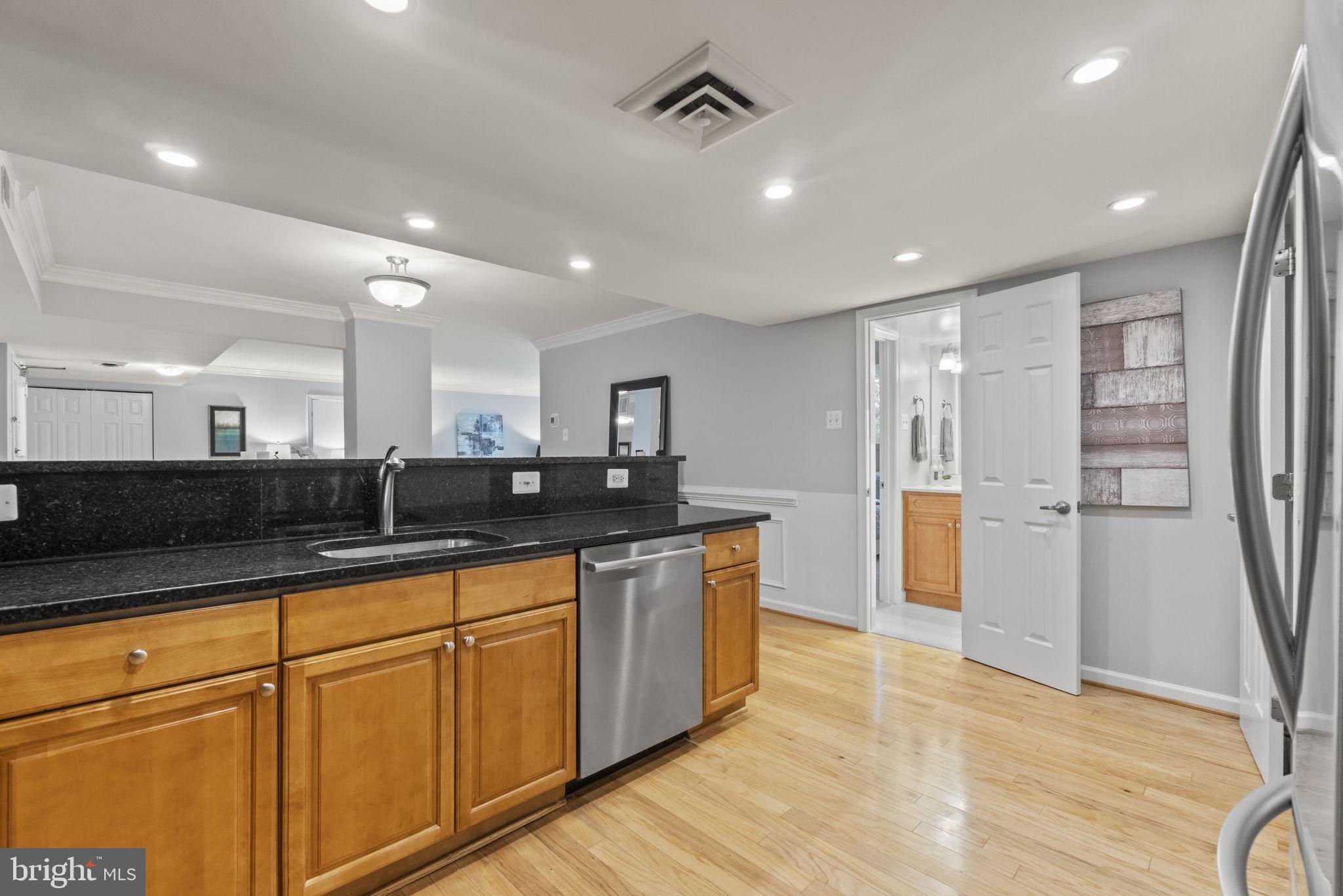 1515 South Arlington Ridge Road, Unit 603 Arlington, VA 22202 - Photo 6 of 22 a view of a kitchen with stainless steel appliances granite countertop a refrigerator and a sink