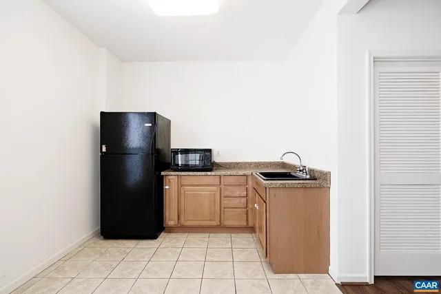 a kitchen with a refrigerator and a stove