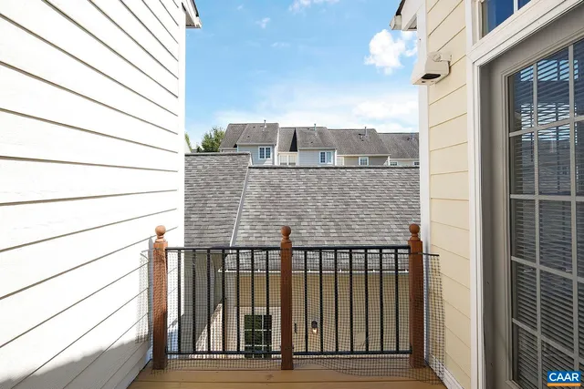 a view of a house with a small yard and wooden fence