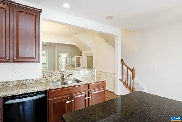 a bathroom with granite countertop a sink and a mirror