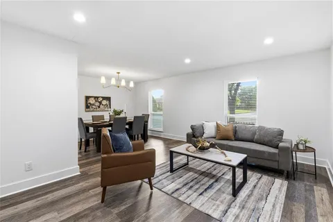 a living room with furniture a rug and a window