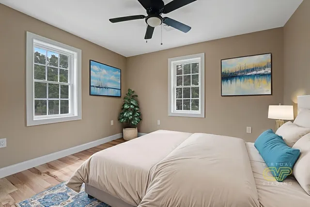 a bedroom with a bed and wooden floor