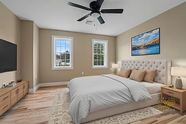 a bedroom with a large bed and a flat screen tv