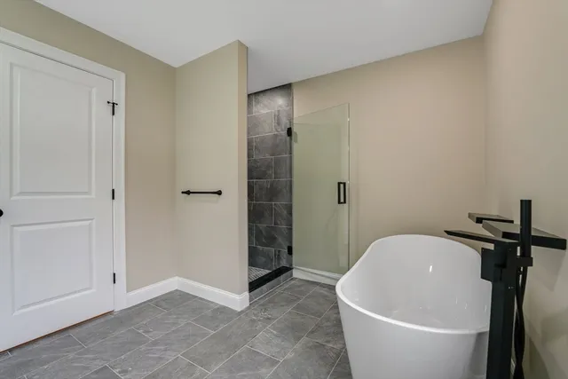 a white bath tub sitting in a bathroom