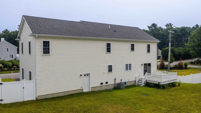 a backyard of a house with table and chairs
