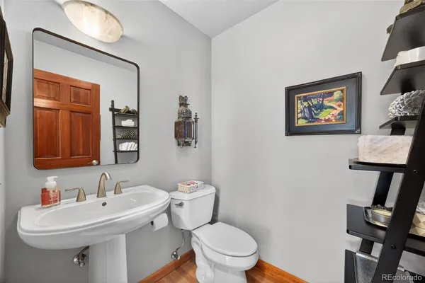 a bathroom with a sink mirror and toilet