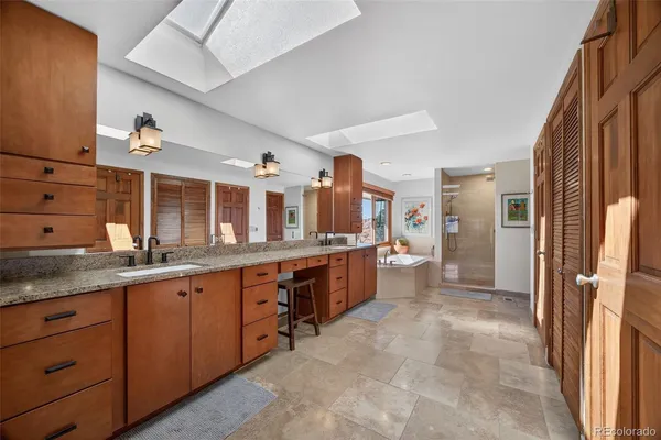 a large kitchen with stainless steel appliances a sink and cabinets