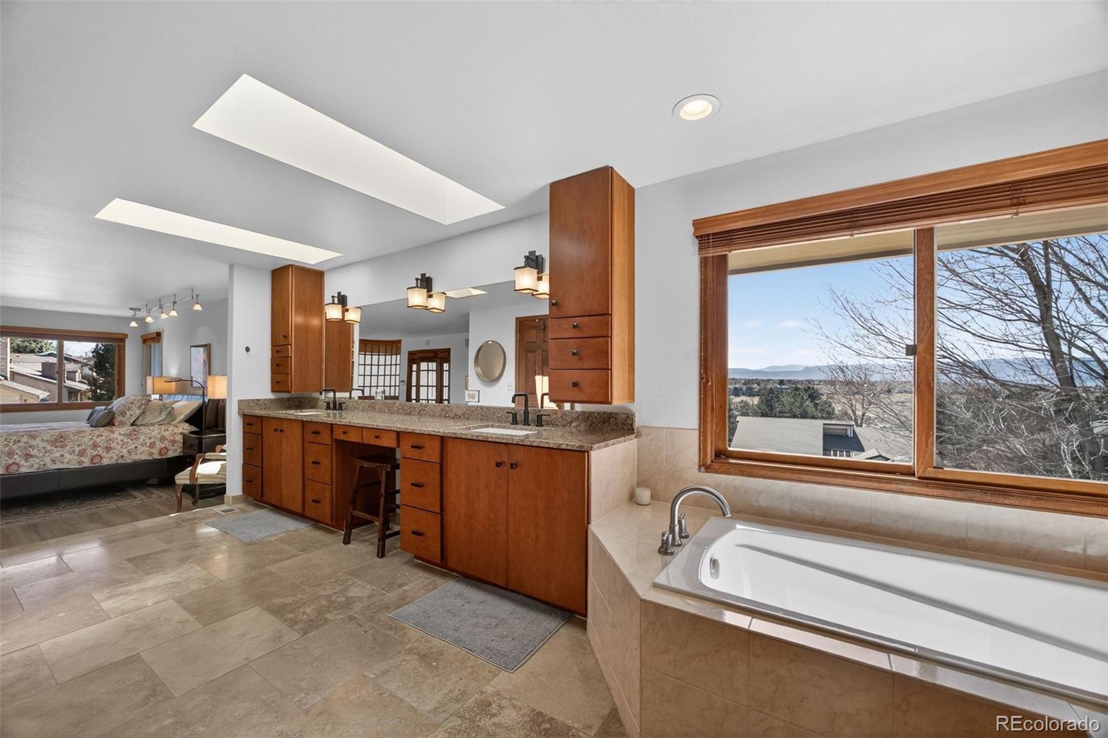 2452 Terraridge Drive Highlands Ranch, CO 80126 - Photo 22 of 50 a bathroom with a granite countertop sink and a large mirror
