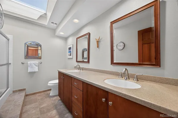a bathroom with a granite countertop sink vanity and mirror