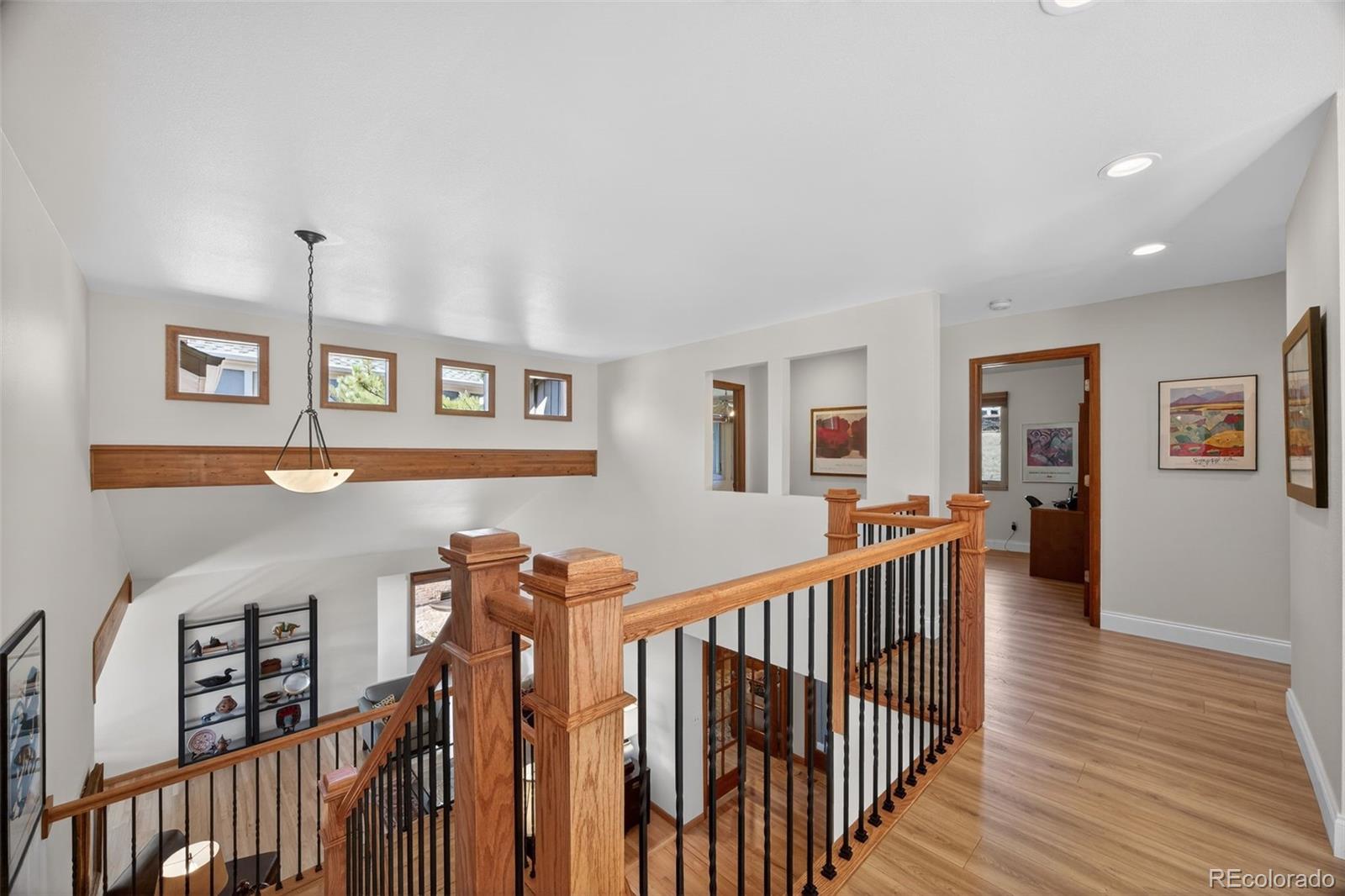 2452 Terraridge Drive Highlands Ranch, CO 80126 - Photo 30 of 50 a view of a hallway with wooden floor and furniture
