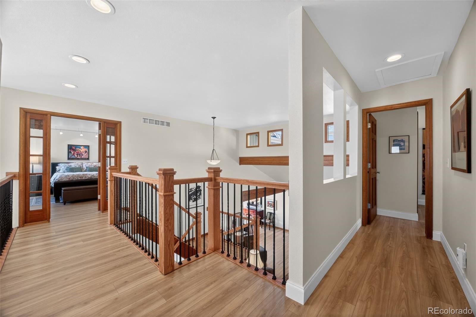 2452 Terraridge Drive Highlands Ranch, CO 80126 - Photo 31 of 50 a view of a hallway with wooden floor and stairs