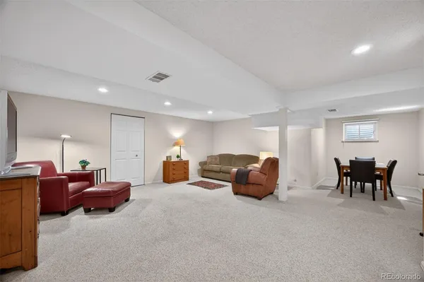 a living room with furniture and next to a window