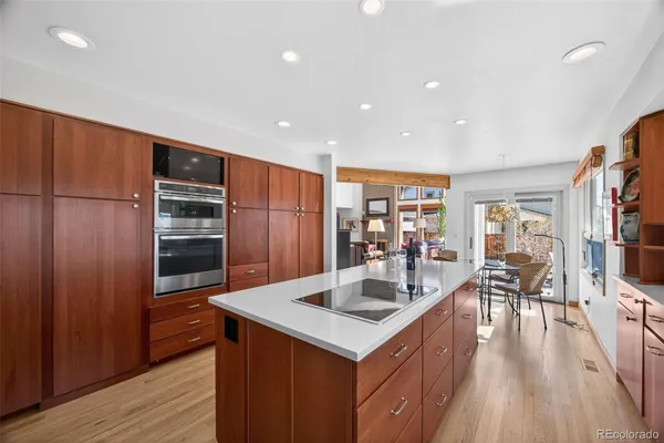 a kitchen with stainless steel appliances granite countertop a refrigerator a sink and a stove