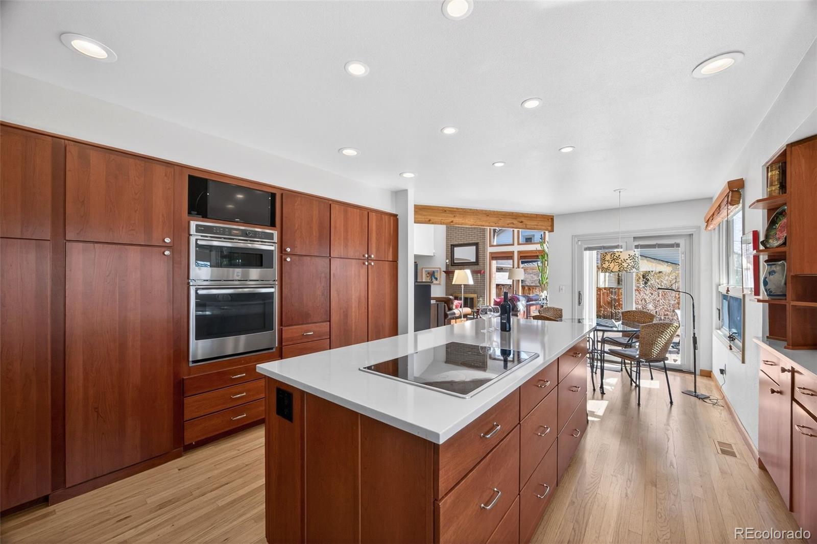 2452 Terraridge Drive Highlands Ranch, CO 80126 - Photo 7 of 50 a kitchen with stainless steel appliances granite countertop a refrigerator a sink and a stove