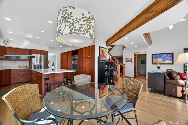 a living room with furniture a flat screen tv and kitchen view