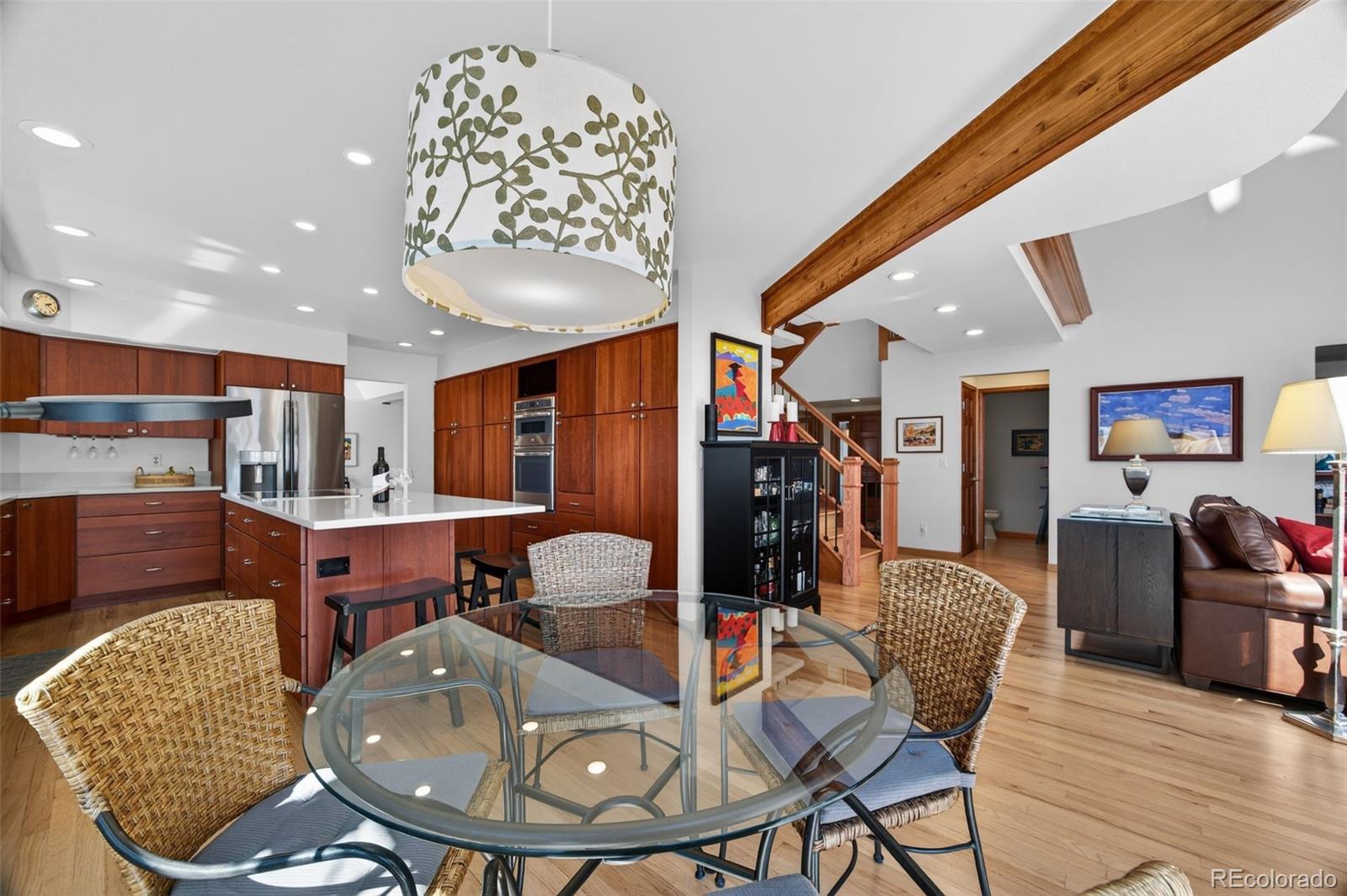 2452 Terraridge Drive Highlands Ranch, CO 80126 - Photo 10 of 50 a living room with furniture a flat screen tv and kitchen view