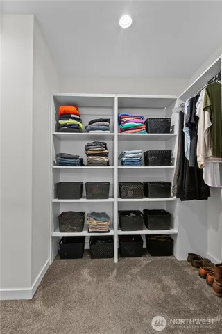 a view of walk in closet with empty racks