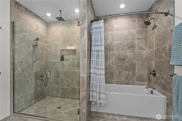 a bathroom with a bathtub and a shower