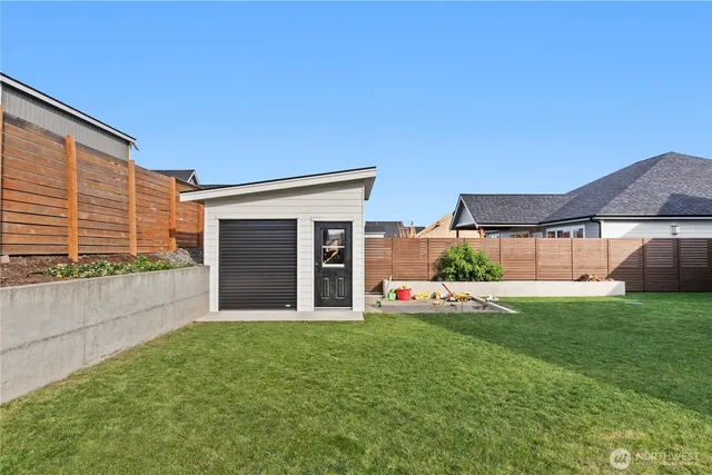 a view of a house with backyard and sitting area