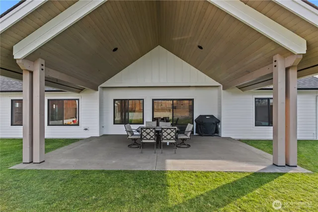 a view of a house with a yard and sitting area