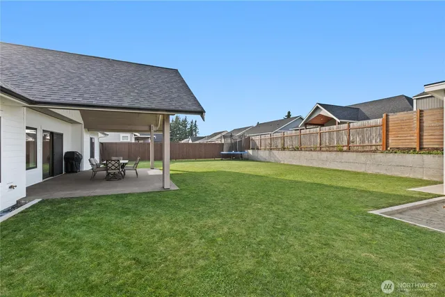 a view of a house with a yard and sitting area