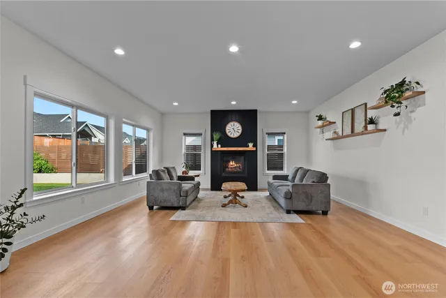 a living room with furniture and large windows
