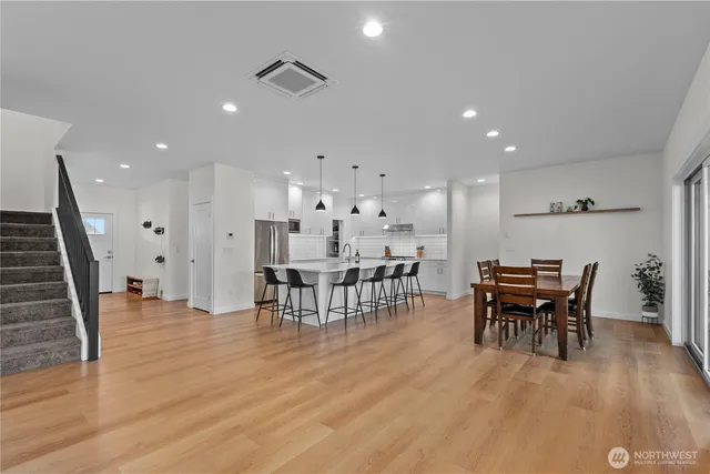 a view of a dining room with furniture and wooden floor
