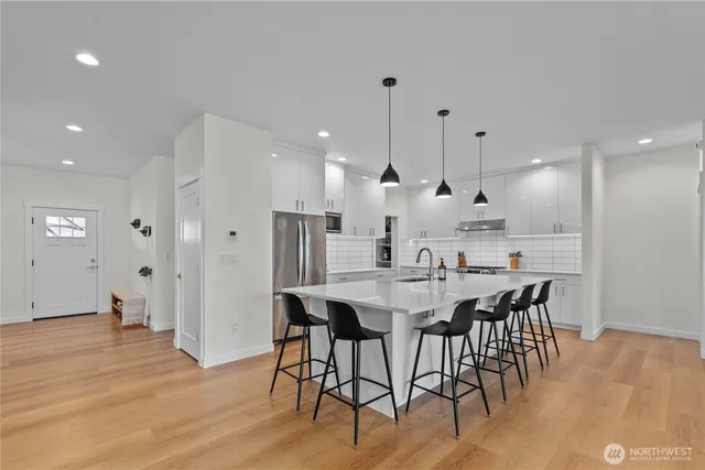 a large kitchen with a table and chairs