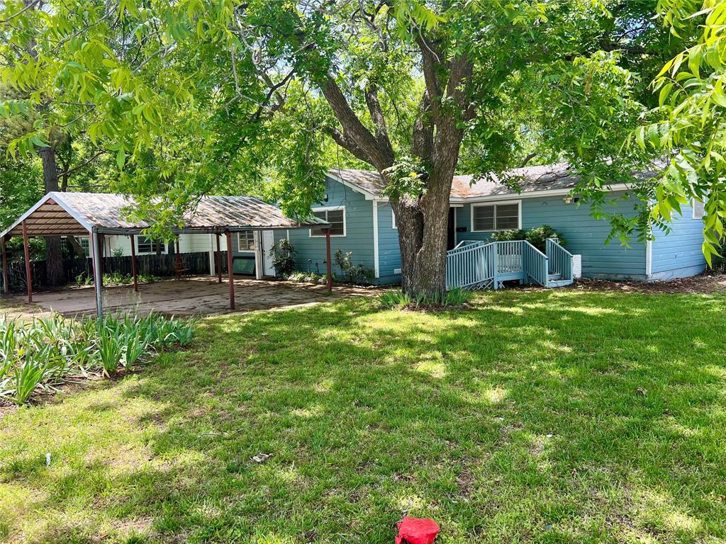 200 Dallas Street Nocona, TX 76255 - Photo 1 of 29 a view of a house with backyard and sitting area