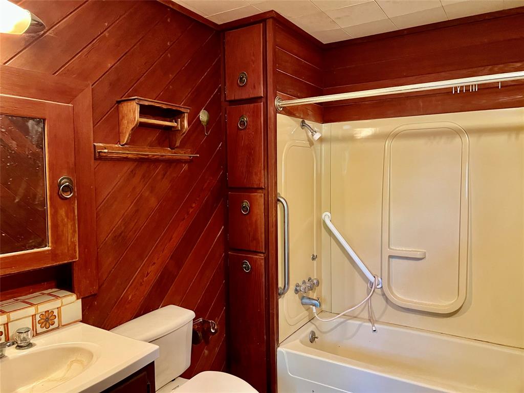 200 Dallas Street Nocona, TX 76255 - Photo 11 of 29 a bathroom with a sink and a mirror