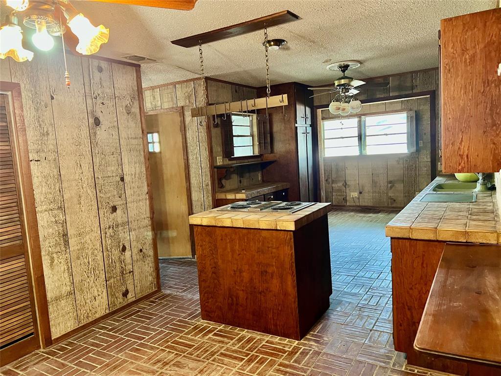 200 Dallas Street Nocona, TX 76255 - Photo 12 of 29 a bathroom with sink shower and mirror