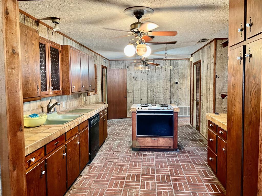 200 Dallas Street Nocona, TX 76255 - Photo 2 of 29 a large bathroom with a double vanity sink a double vanity and a mirror