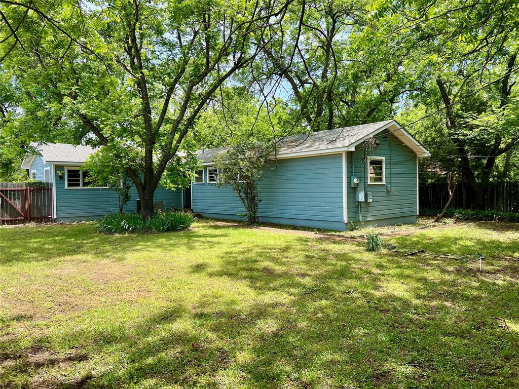 200 Dallas Street Nocona, TX 76255 - Photo 4 of 29 a house with a tree in front of it