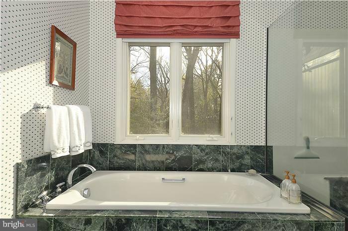 913 Poplar Hill Road Baltimore, MD 21210 - Photo 16 of 21 a bathroom with a tub and shower