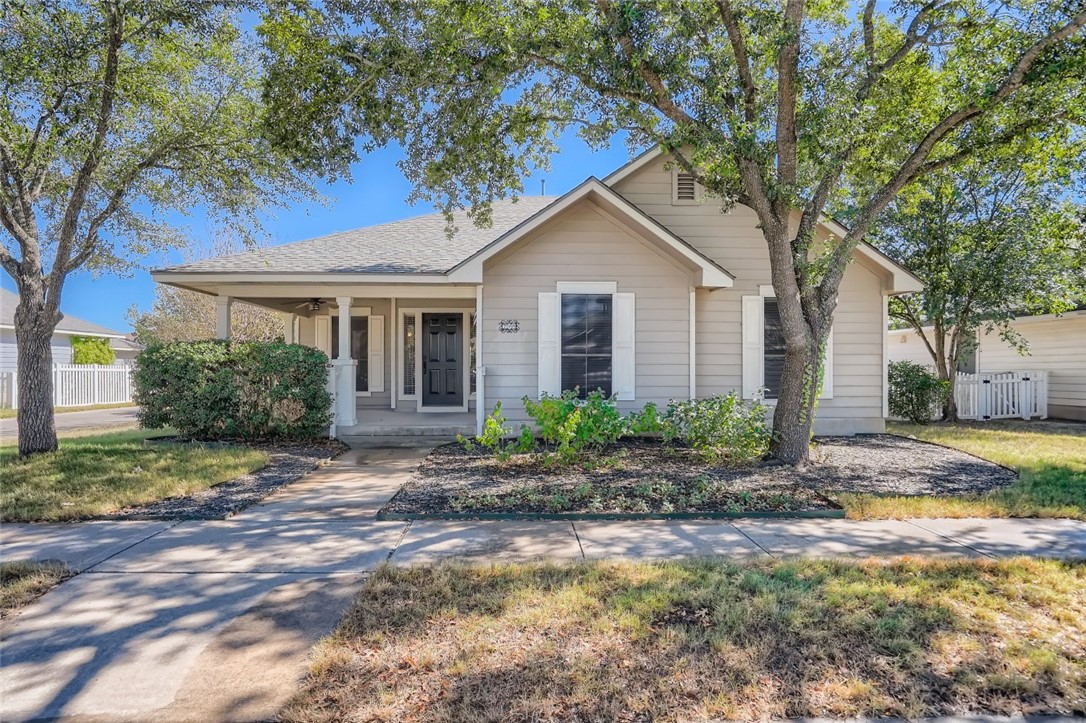 a view of a house with yard and tree s