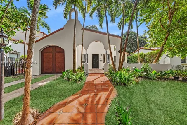 a front view of a house with a garden
