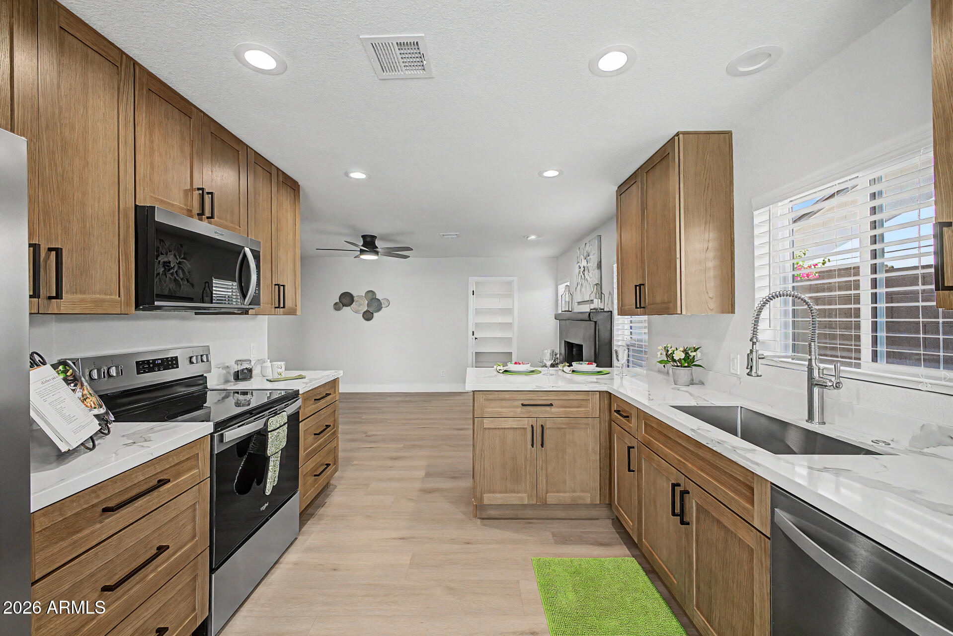 1009 West Pampa Avenue Mesa, AZ 85210 - Photo 6 of 31 a large kitchen with stainless steel appliances granite countertop a sink and a stove