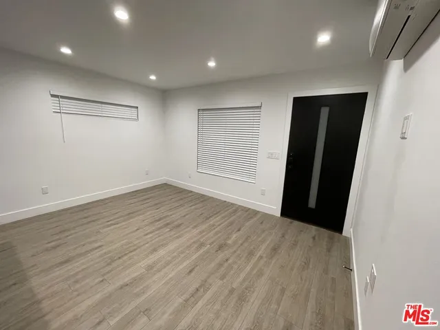an empty room with wooden floor and closet
