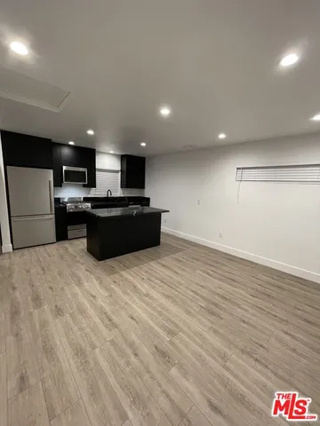 a kitchen with stainless steel appliances a refrigerator sink and microwave