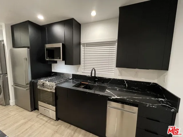 a kitchen with a sink stove and refrigerator
