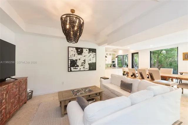 a living room with furniture a window and a flat screen tv