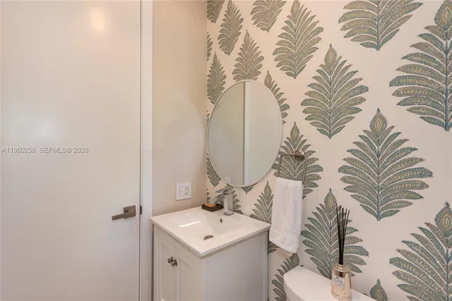 a bathroom with a sink a toilet and mirror