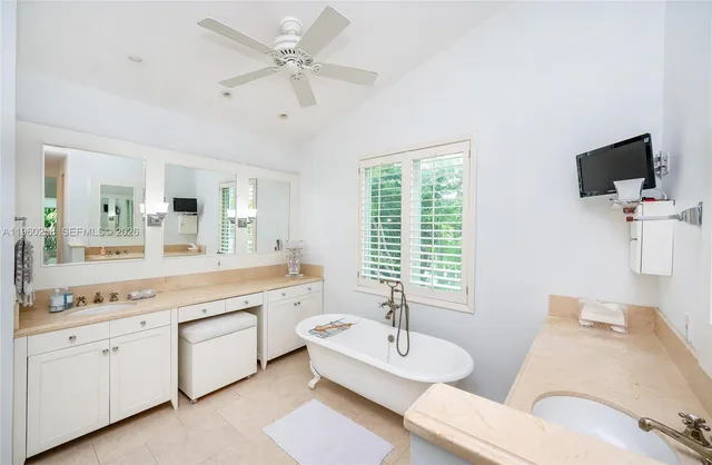 a spacious en suite bathroom with a large mirror and bathtub