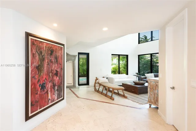 a living room with furniture large window and rug
